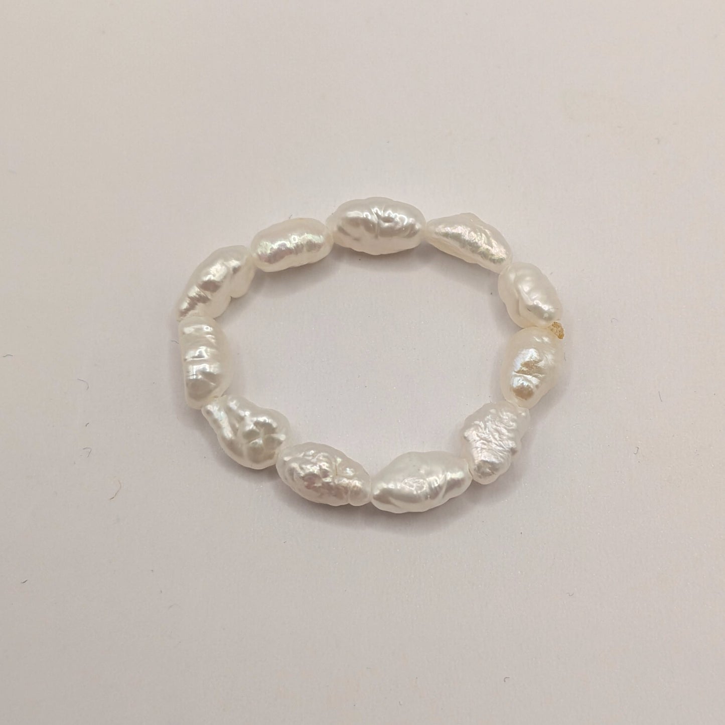 Pearl ring on a light gray background