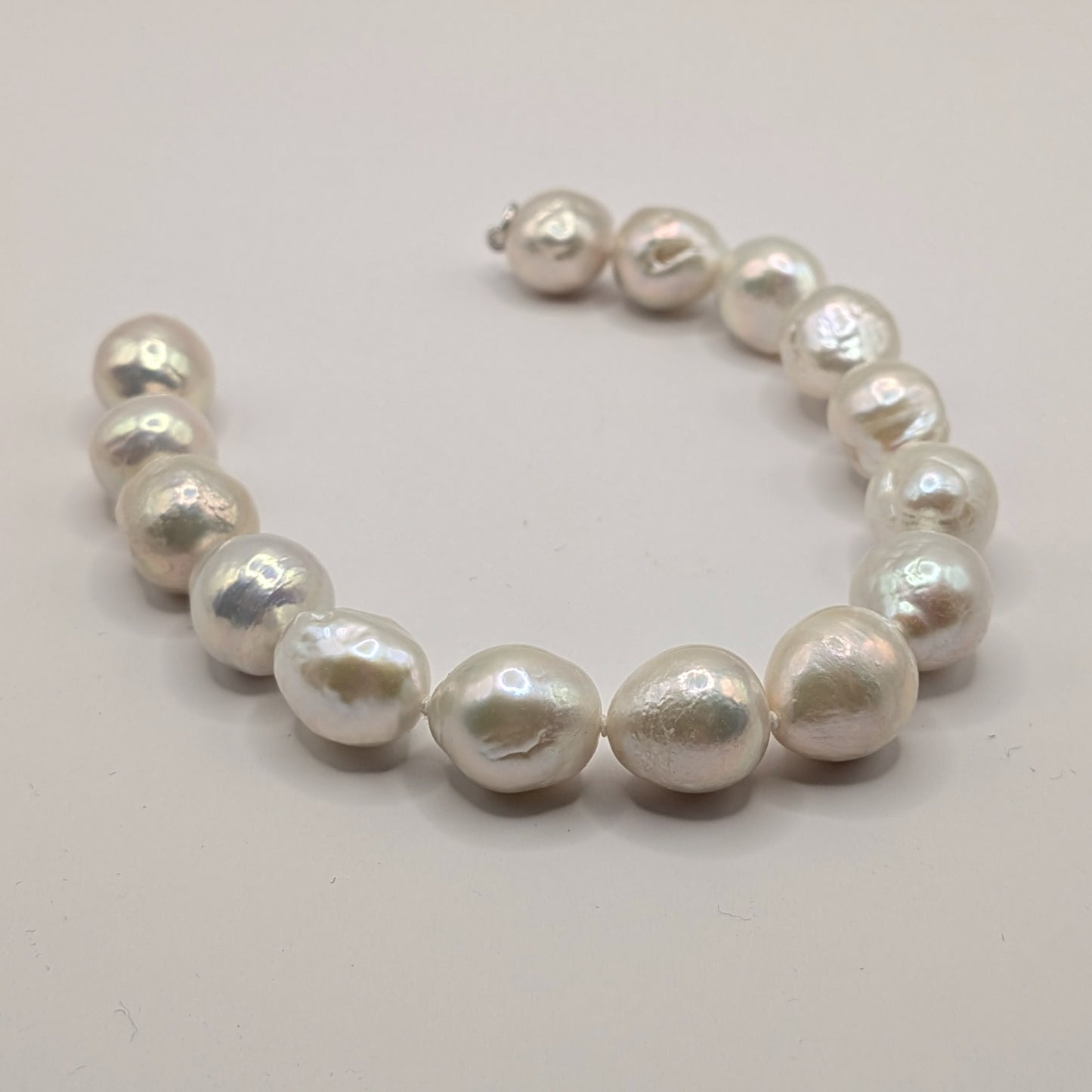 Pearl bracelet on a light gray background