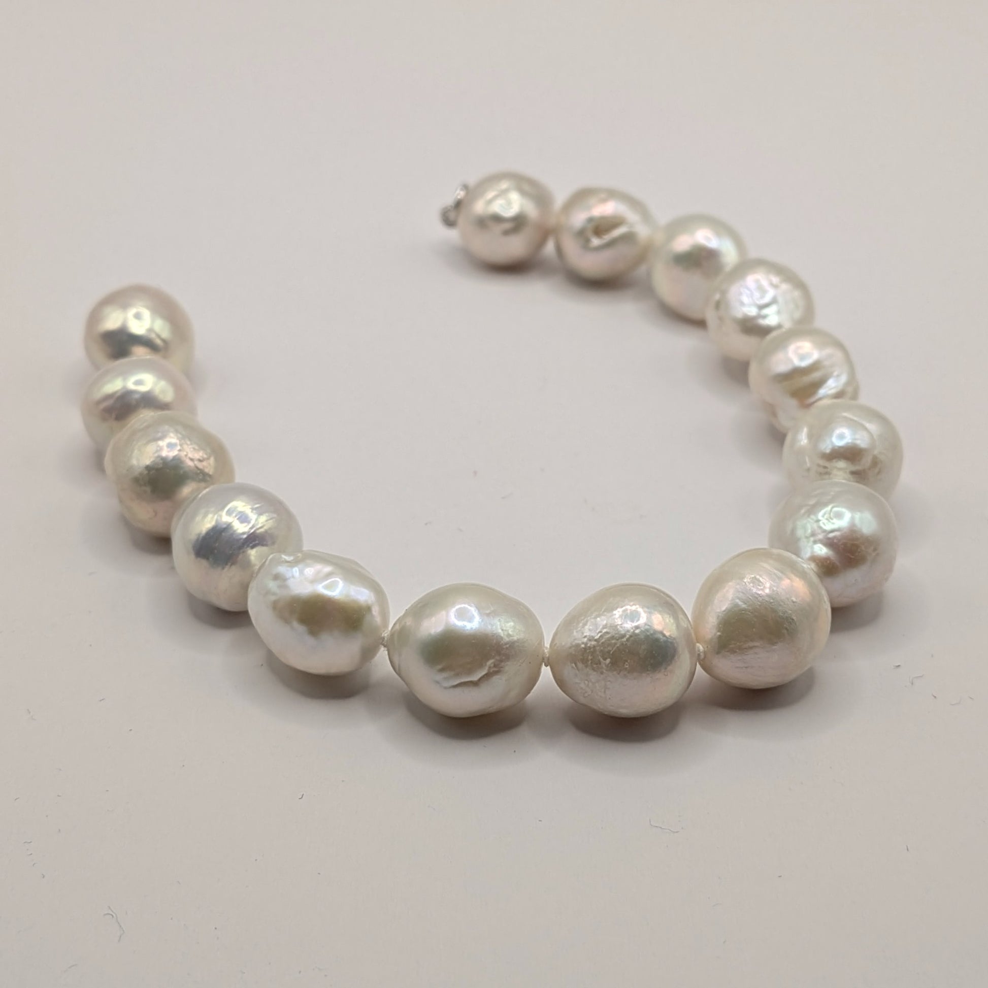 Pearl bracelet on a light gray background