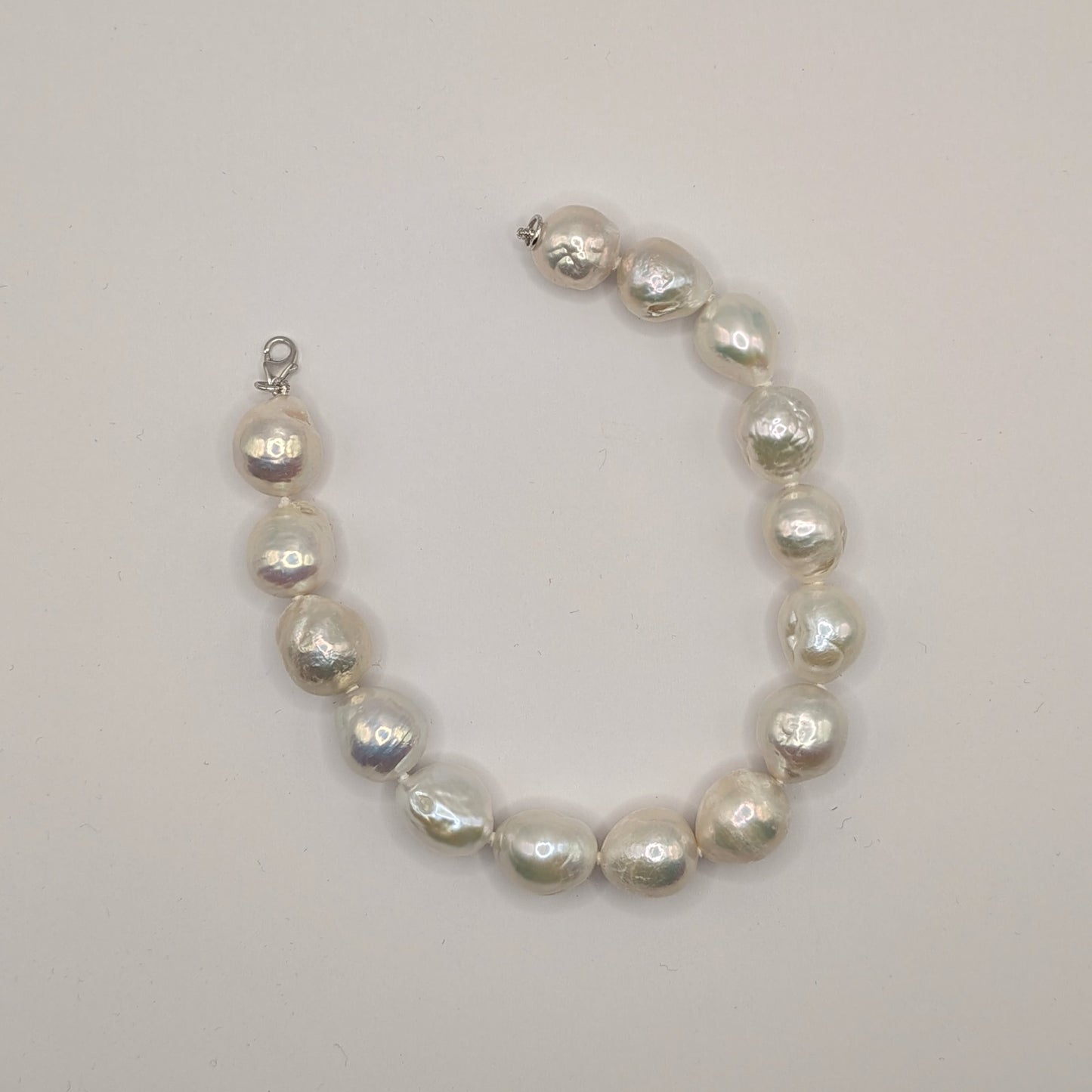 Pearl bracelet on a light gray background