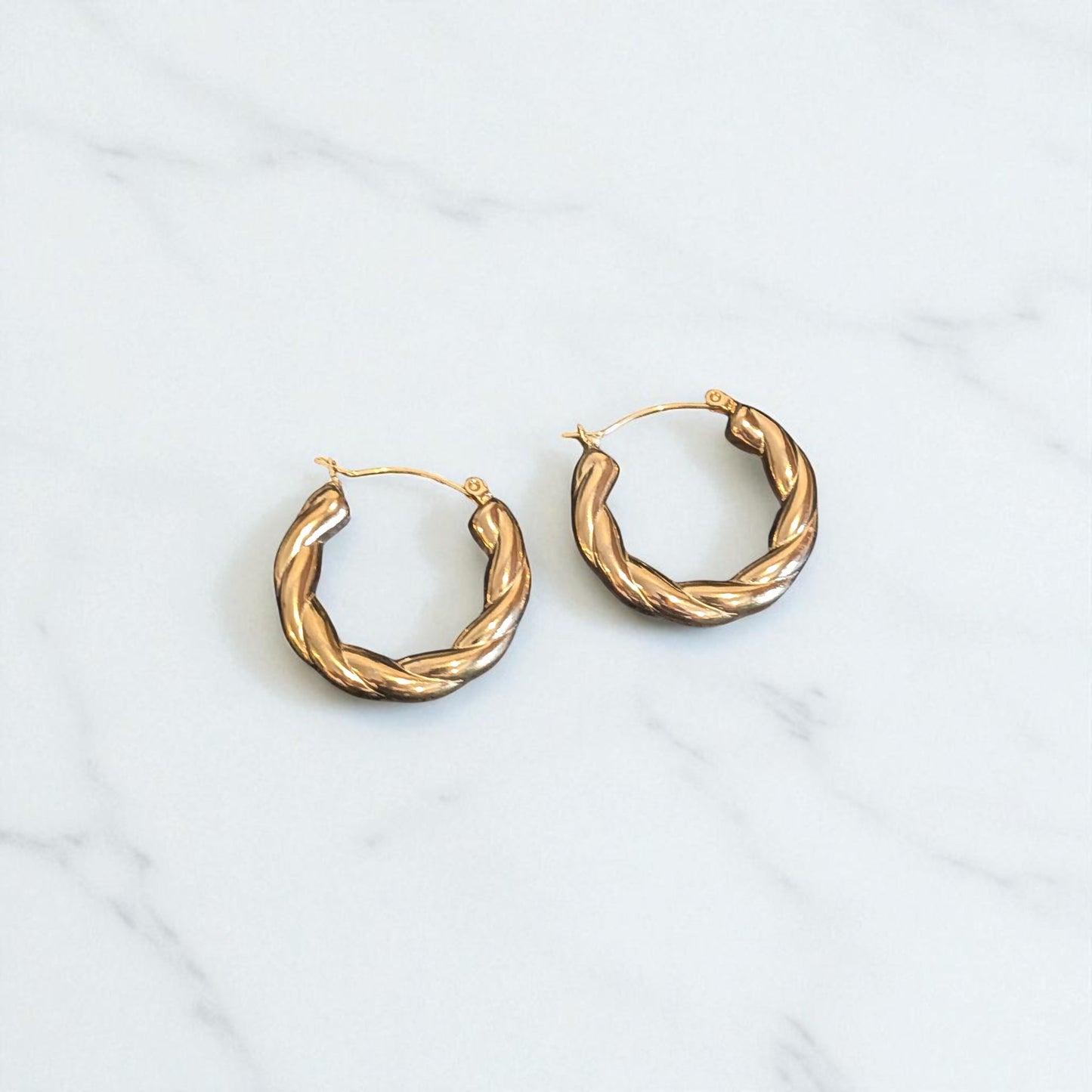 Gold hoop earrings on a white background