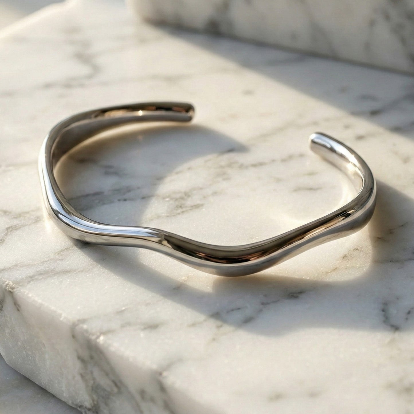 Silver bracelet on a marble surface