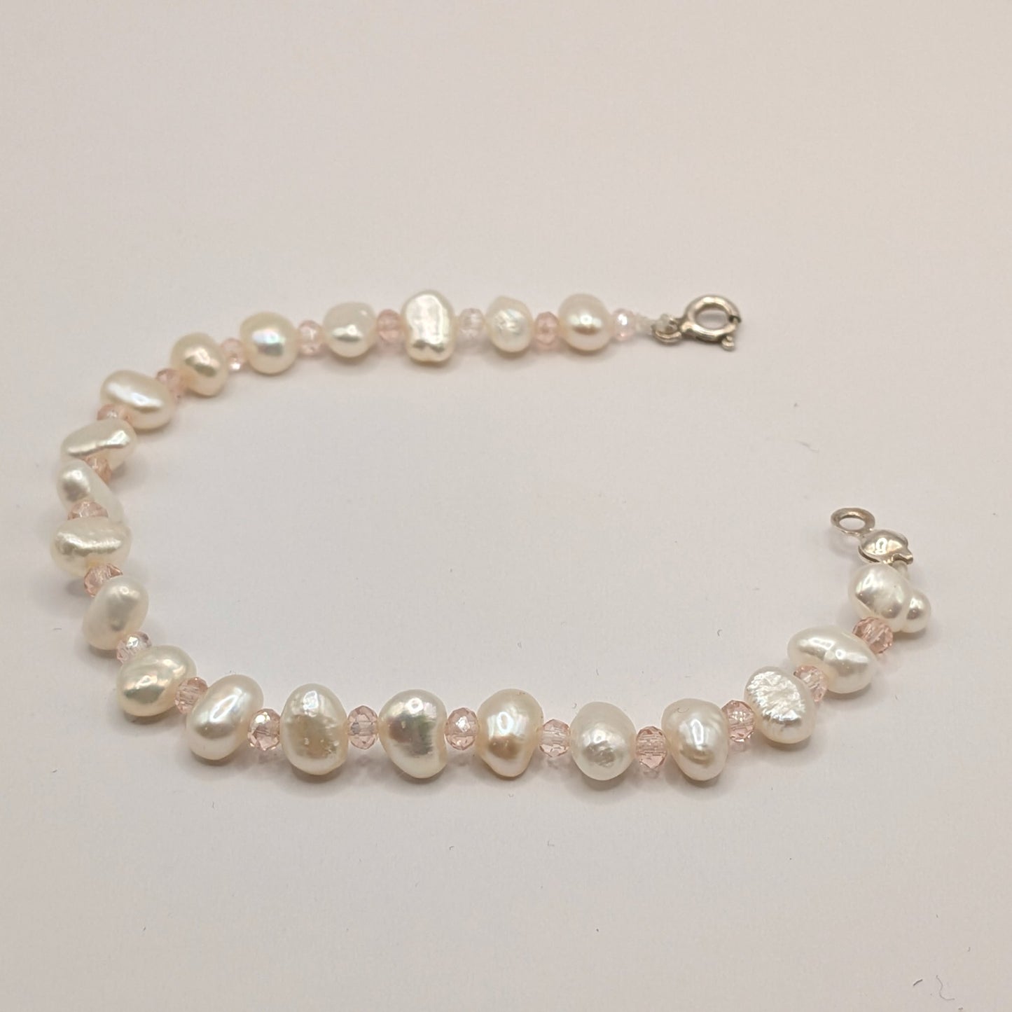 Pearl bracelet on a light gray background