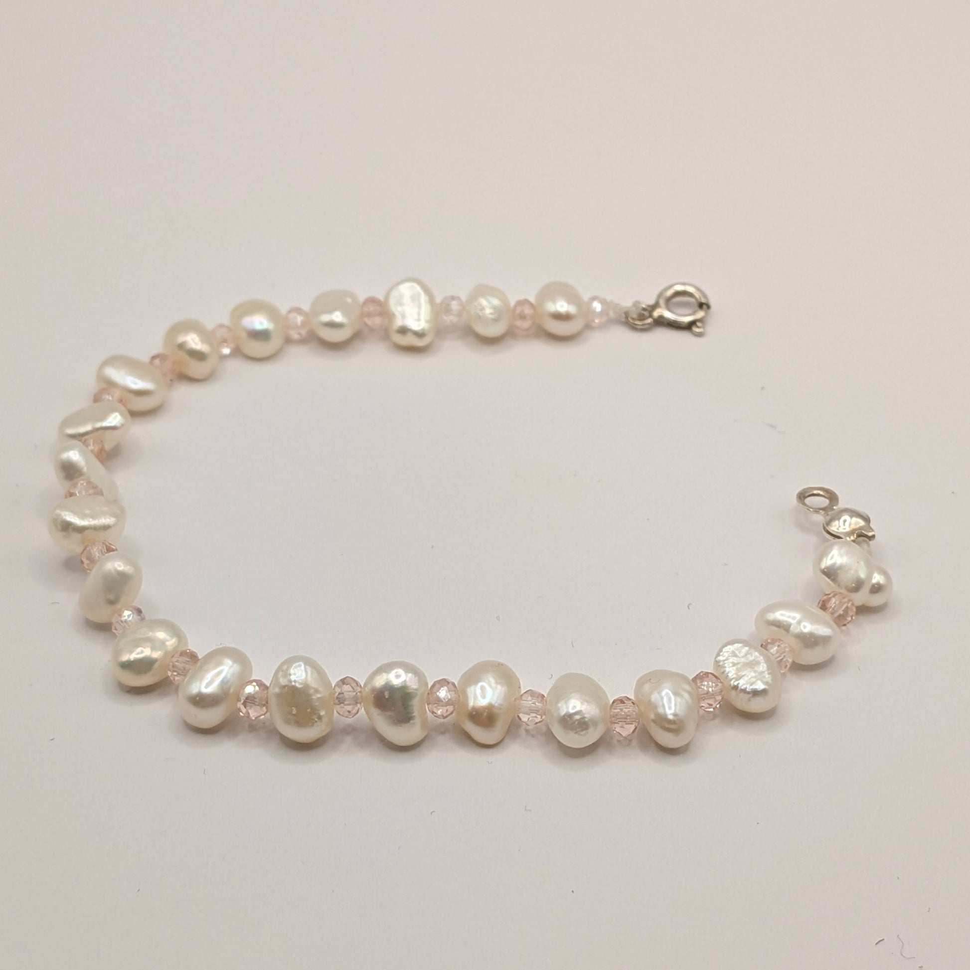 Pearl bracelet on a light gray background