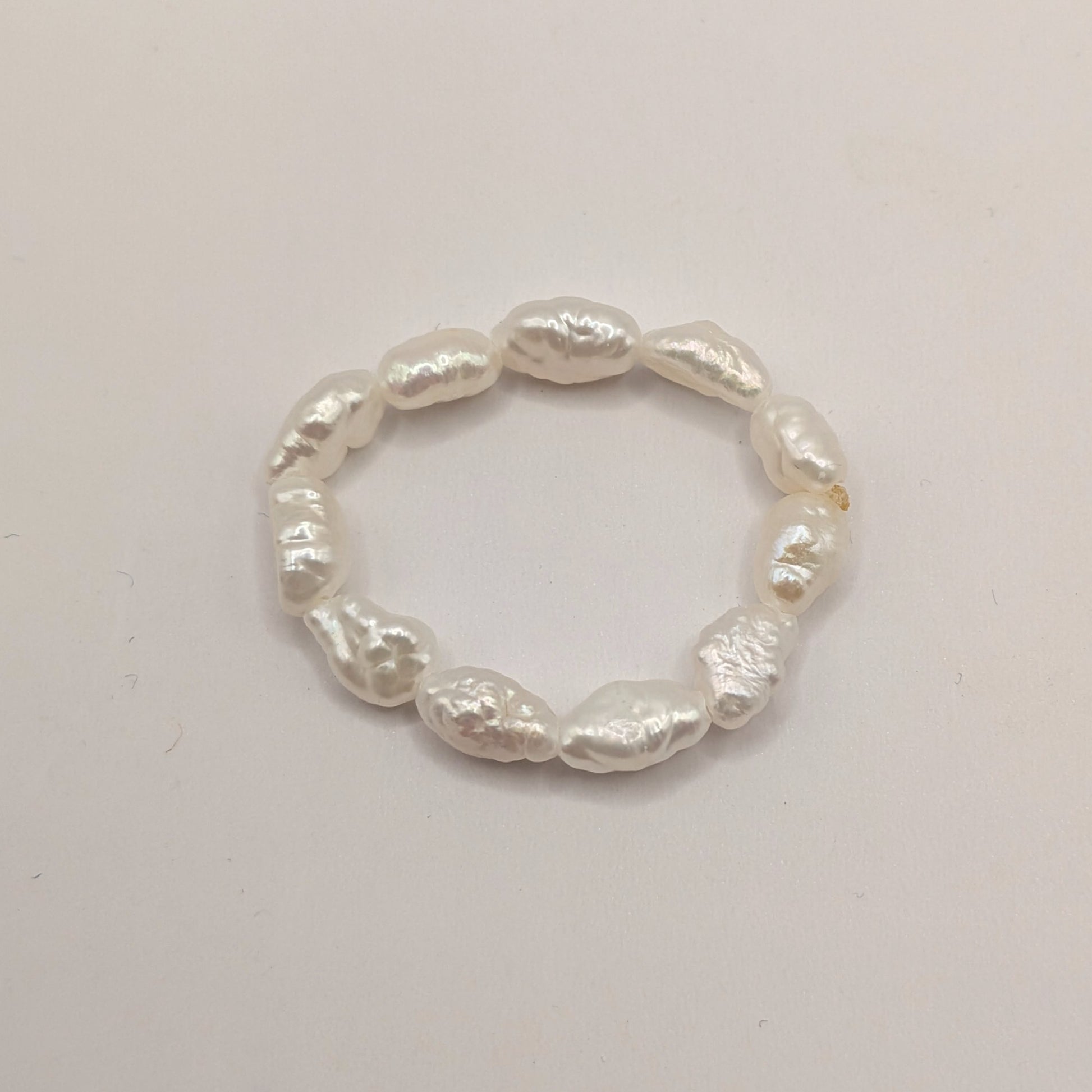 Pearl ring on a light gray background