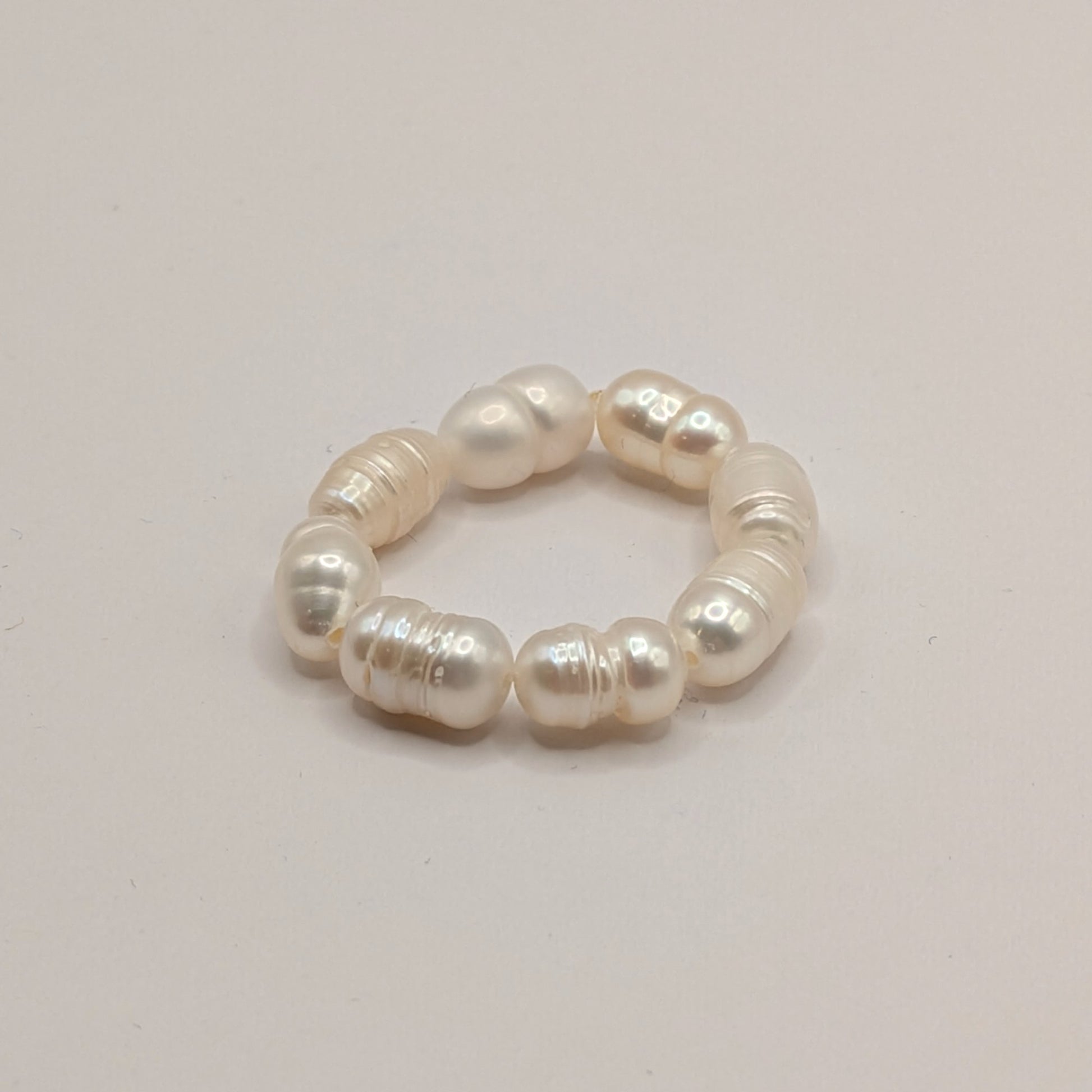 Pearl ring on a light gray background