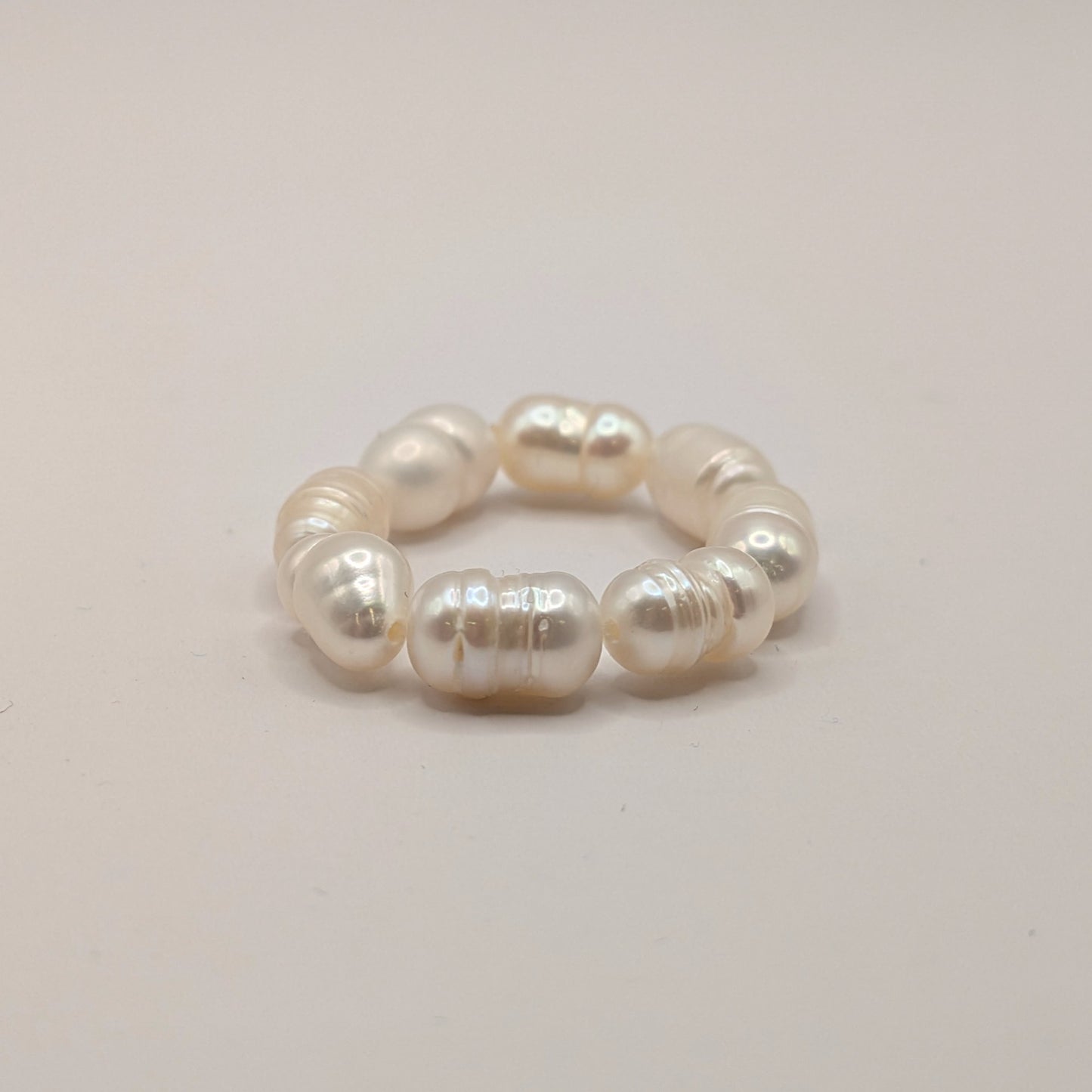 Pearl bracelet on a light gray background
