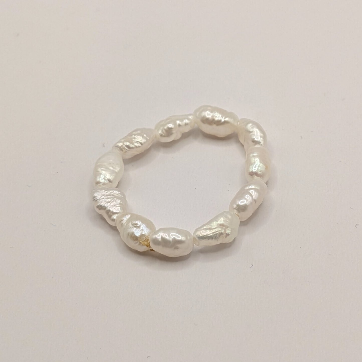 Pearl ring on a light gray background