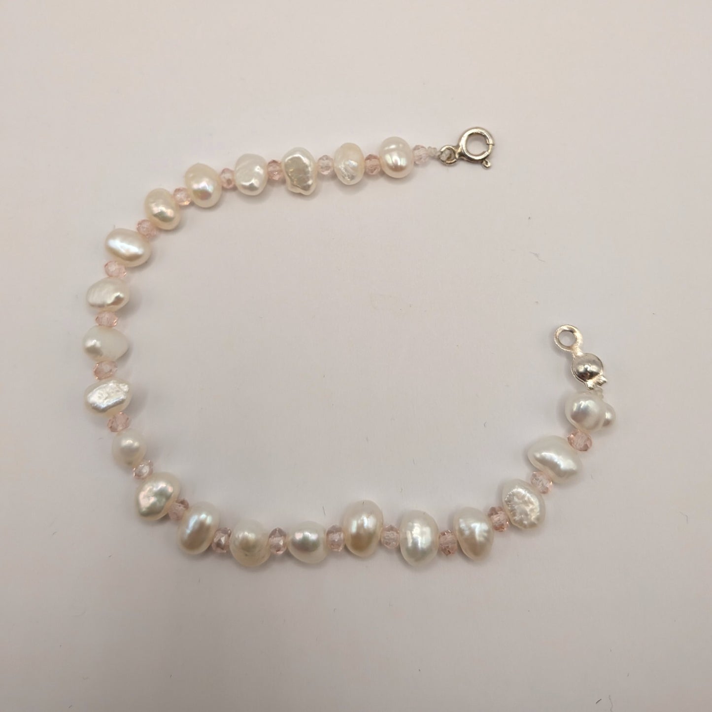Pearl bracelet on a light gray background