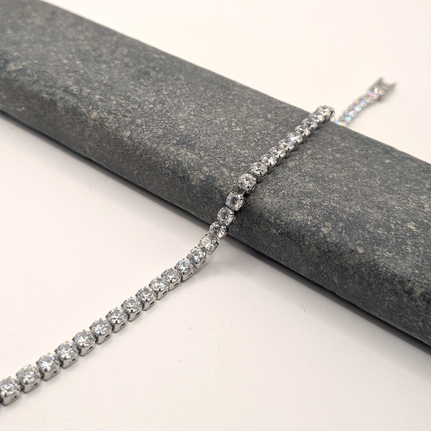Diamond bracelet on a gray stone surface