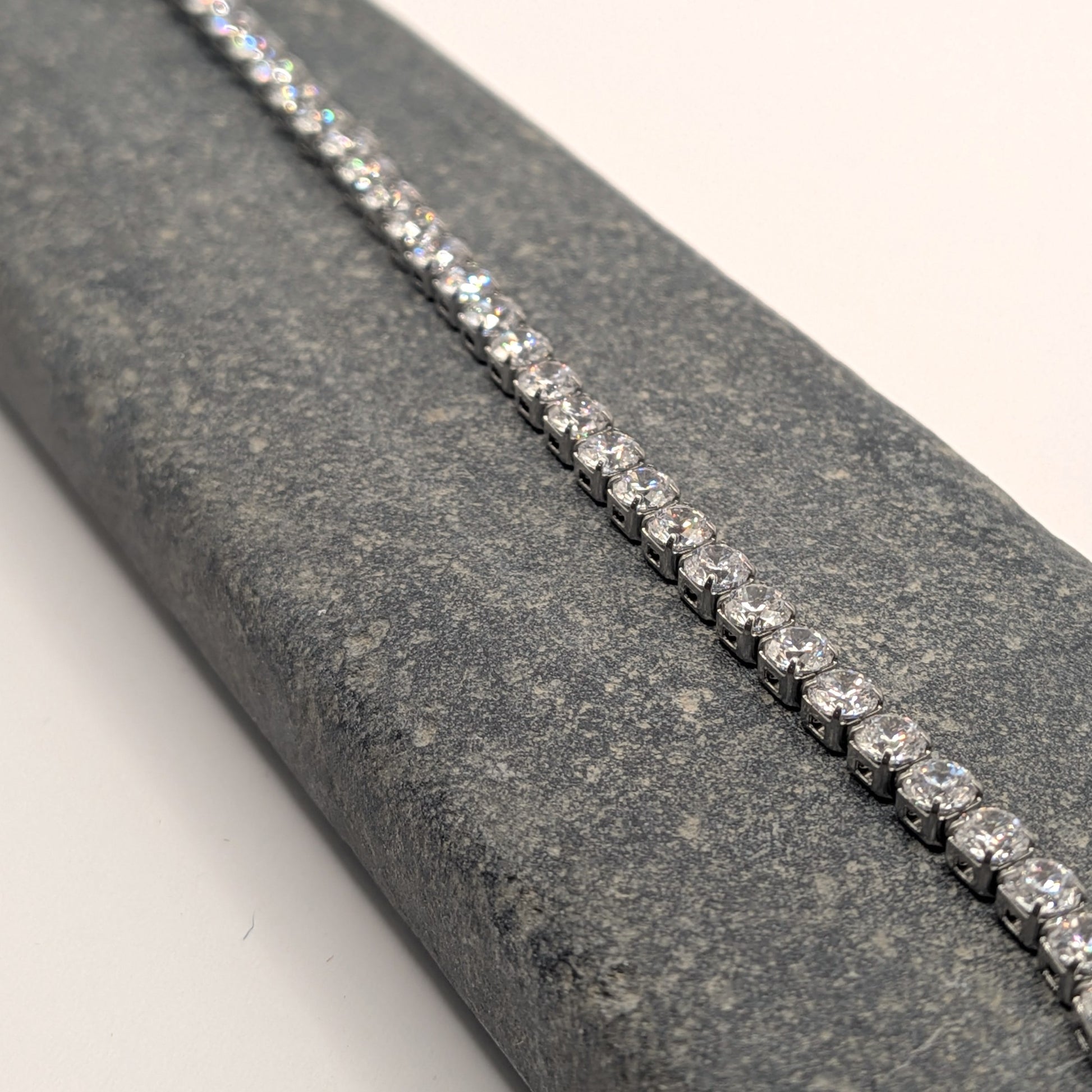 Diamond bracelet on a gray stone surface